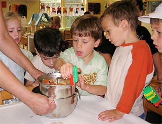Kids making applesauce