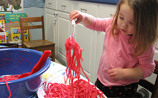 Student serves pink pasta